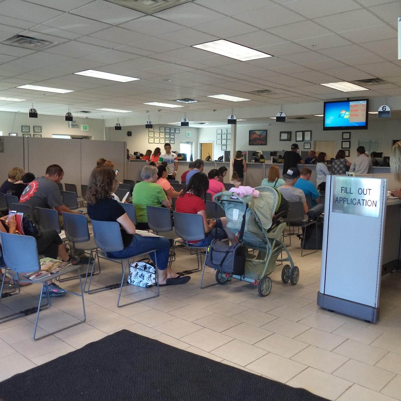 Crowded waiting room with seated people